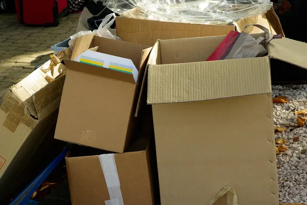 Open cardboard moving boxes being packed with household things