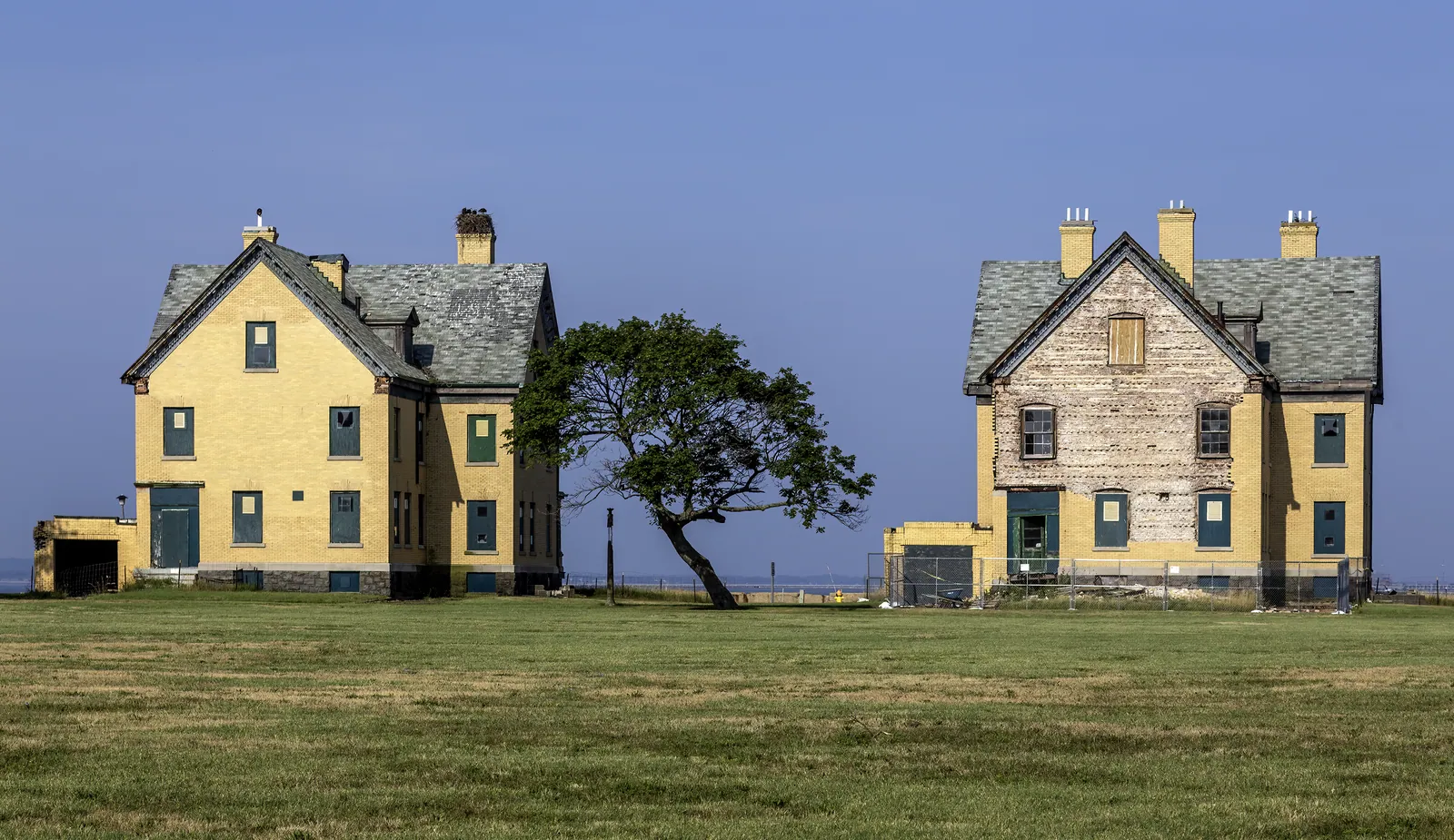 Officer housing in Officer's Row, at Fort Hancock , Gateway National Recreation Area , New Jersey, USA. An osprey nest is on the left house chimney, Sandy...